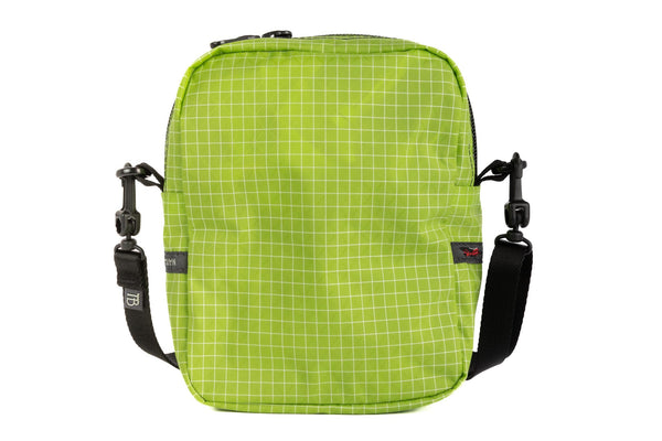 Rear photo of an Everyday Cubelet in Kiwi Halcyon (bright green with a white grid) with a front zipper.